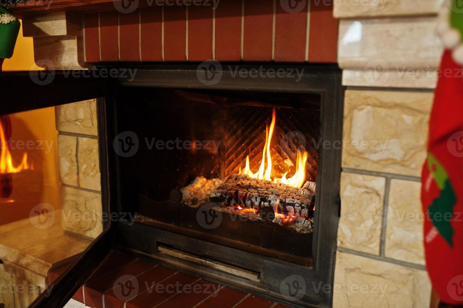 Home fireplace in warm living room on winter day. photo