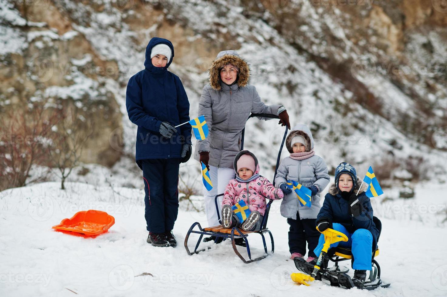 Scandinavian family with Sweden flag in winter swedish landscape. photo