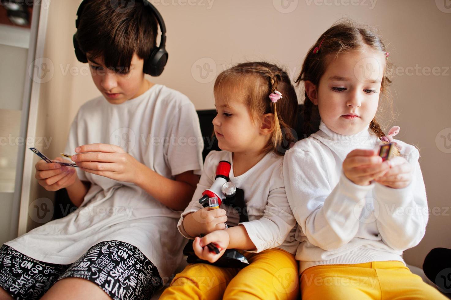 Kids using microscope learning science class at home. photo