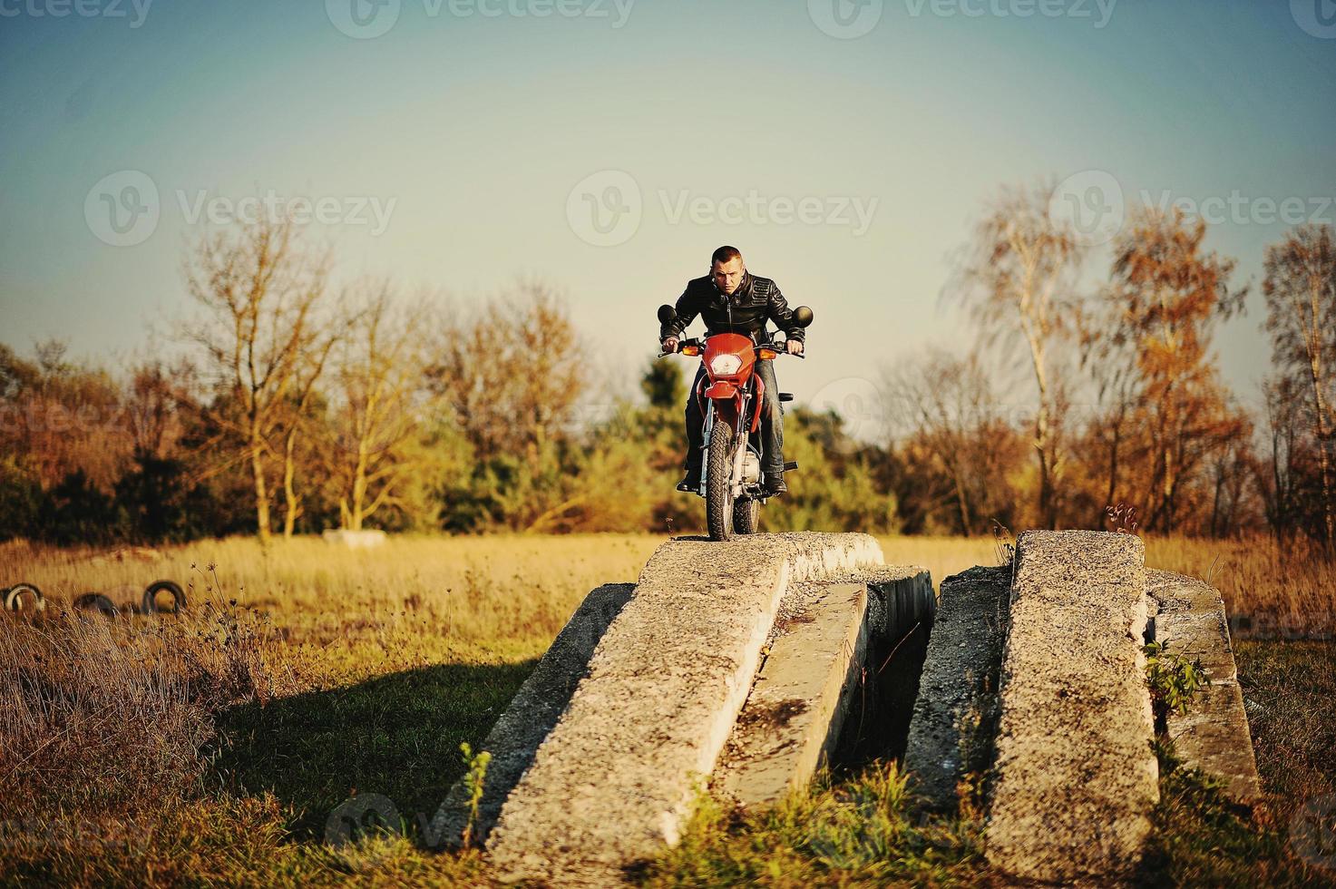 Enduro racer sitting on his motorcycle photo