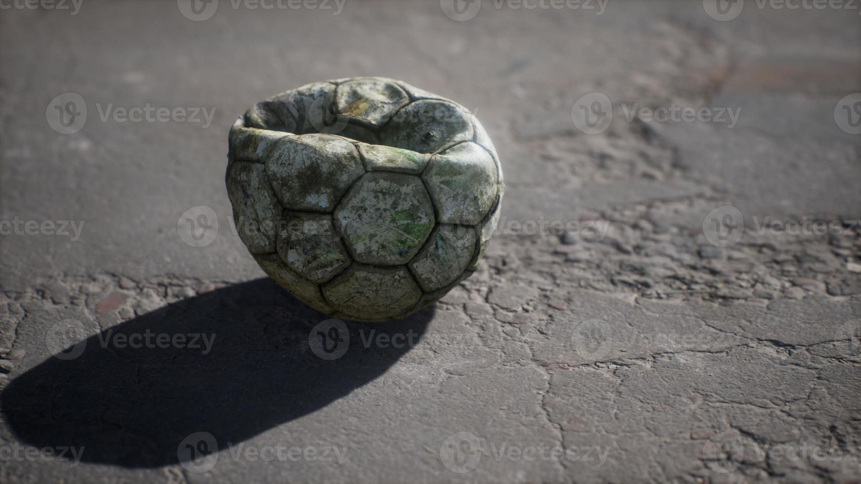 Old soccer ball the cement floor photo