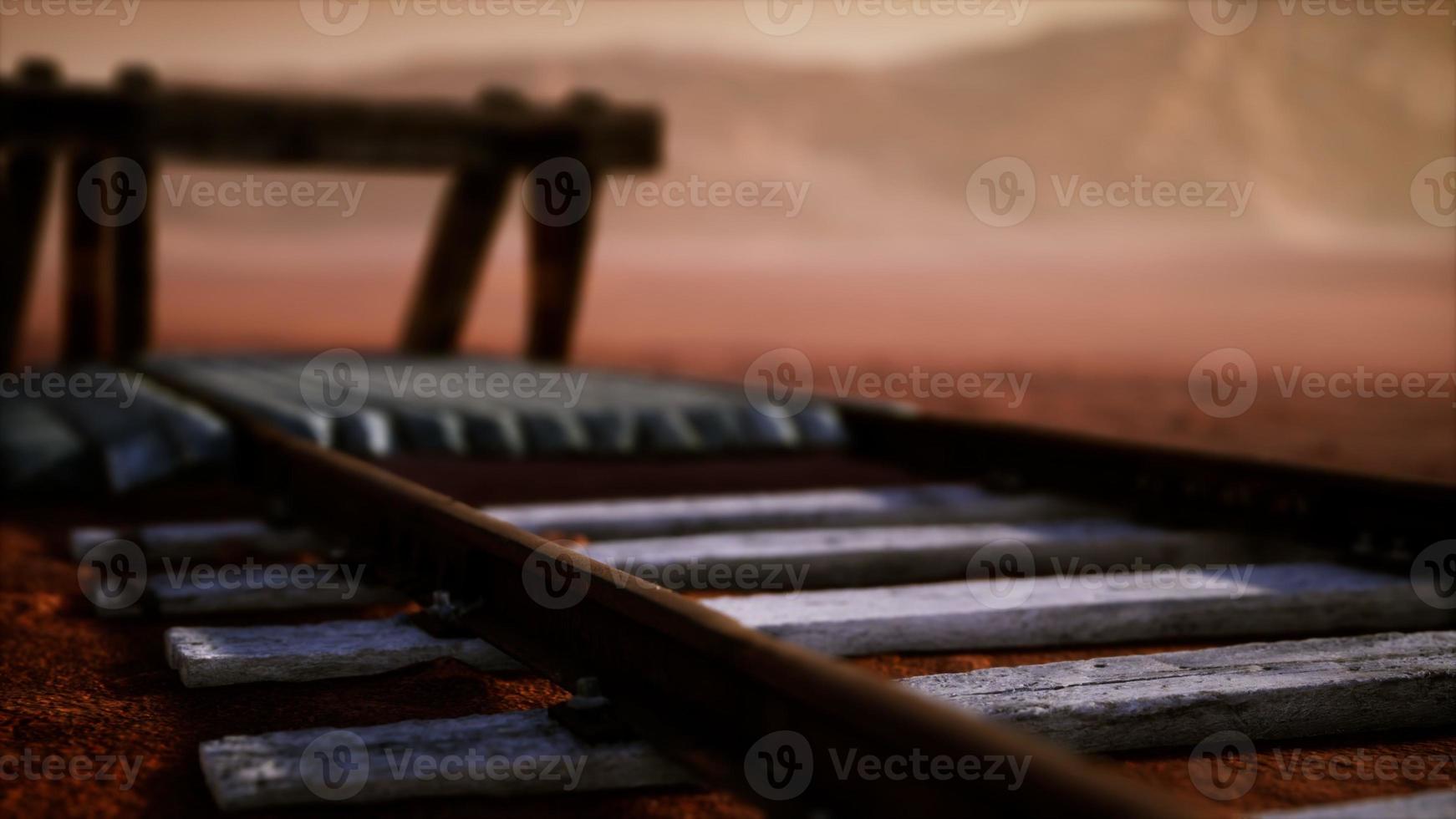 Abandoned railway tracks in the desert photo