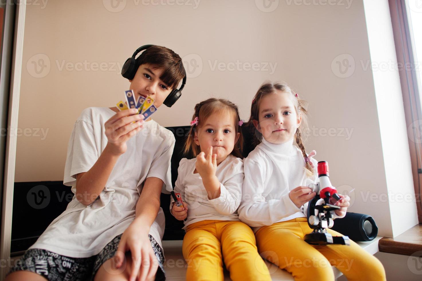 Kids using microscope learning science class at home. photo