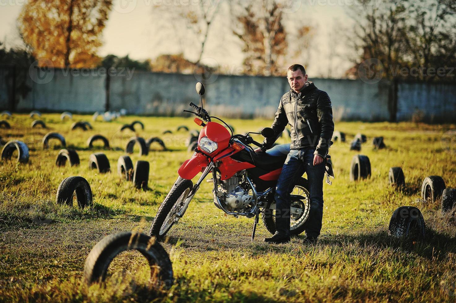 Motorcycle rider stay at sunset with him enduro bike photo