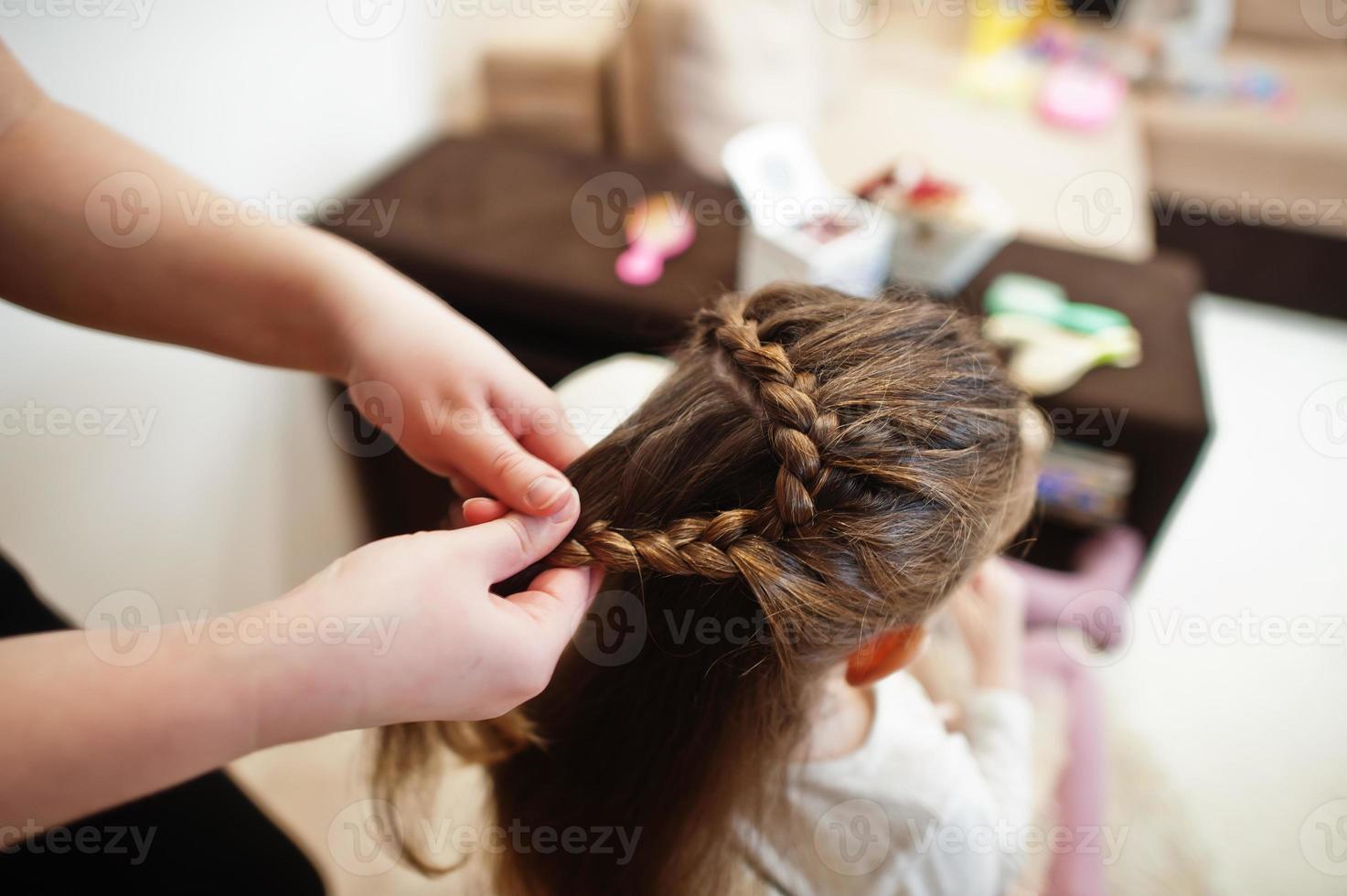 Mother and daughter weekend together at home, mom making hairstyle. photo