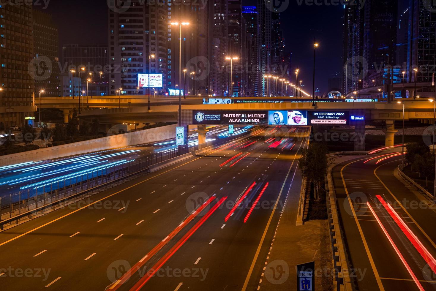 Long exposure of moving cars at night road in Dubai. Nightlife in Dubai Marina. photo