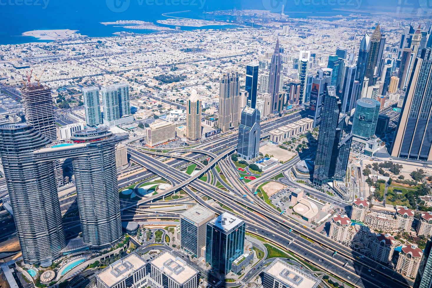 Dubai skyline with beautiful city near it's busiest highway. Amazing view of the junction roads from above. Traffic on the highway. photo