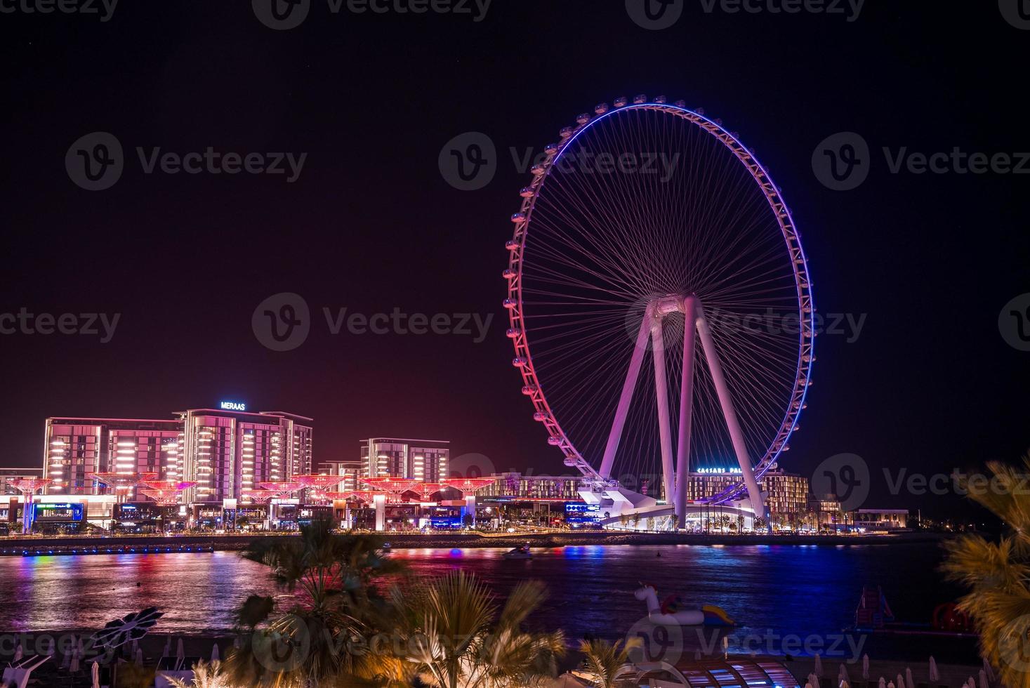 Beautiful Dubai eye or Ain Dubai on the Jumeirah beach at night. Beautiful lights of the ferris wheel in Dubai photo