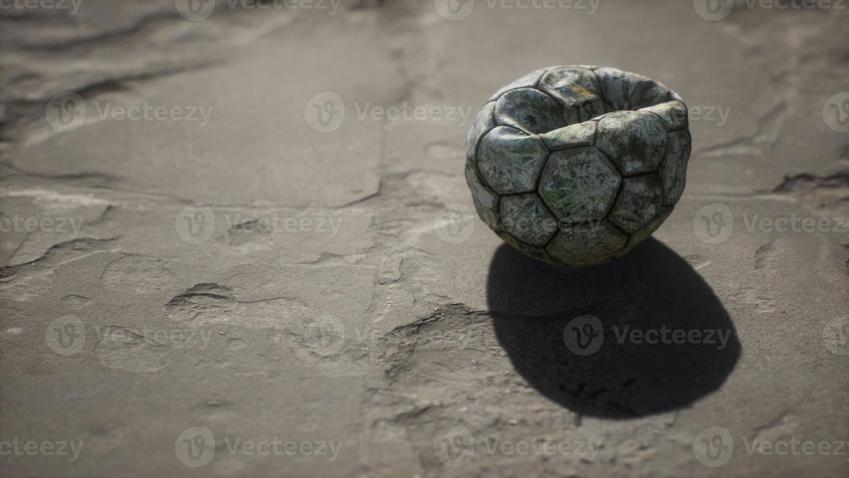 Old soccer ball the cement floor photo