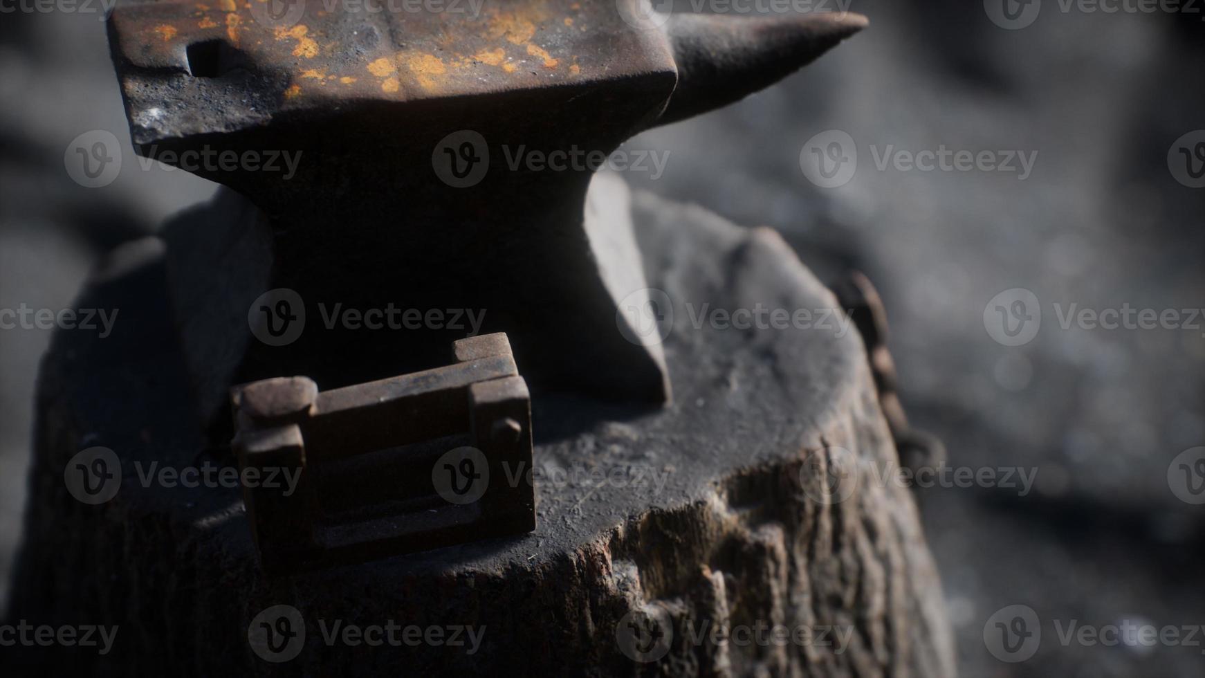 Old anvil attached to a stump photo