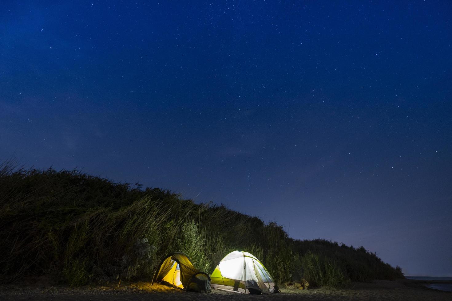 Night landscape with tents and stars on the sky photo