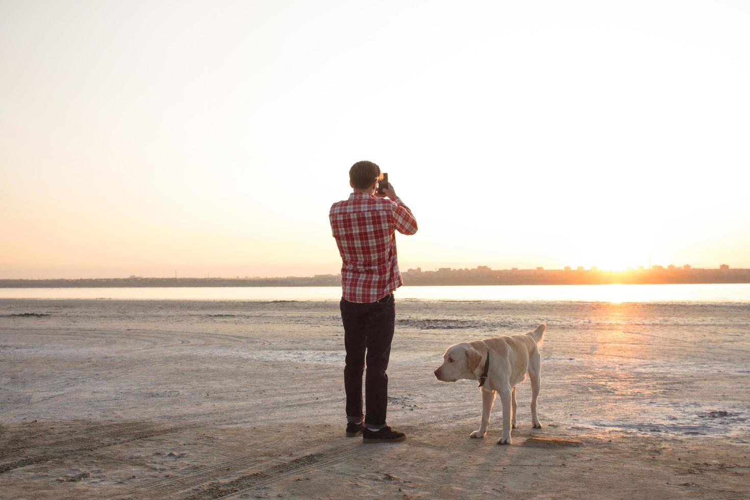 Young male having good time on mornink walk with dog photo