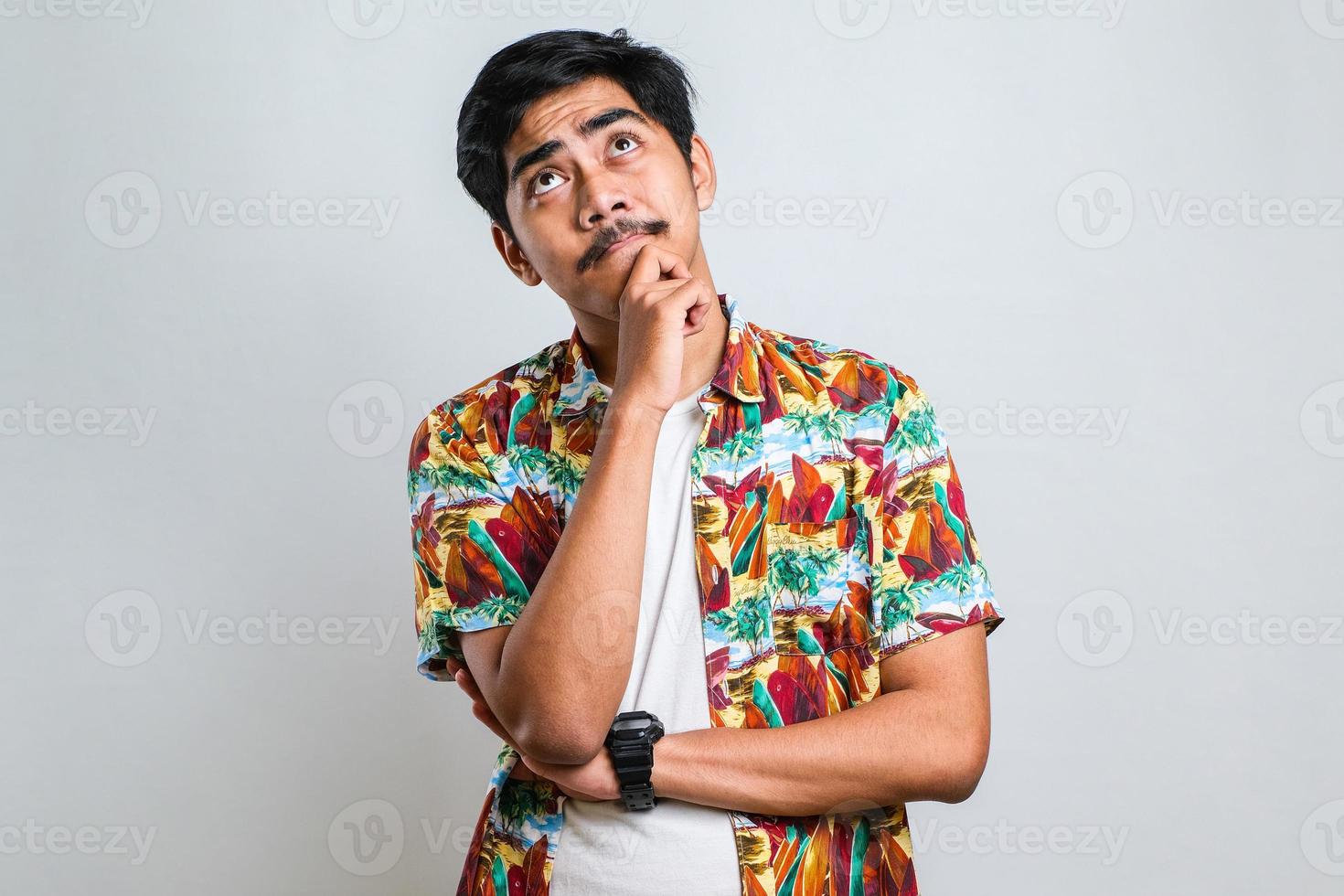 Young handsome man thinking worried about a question, concerned and nervous with hand on chin photo