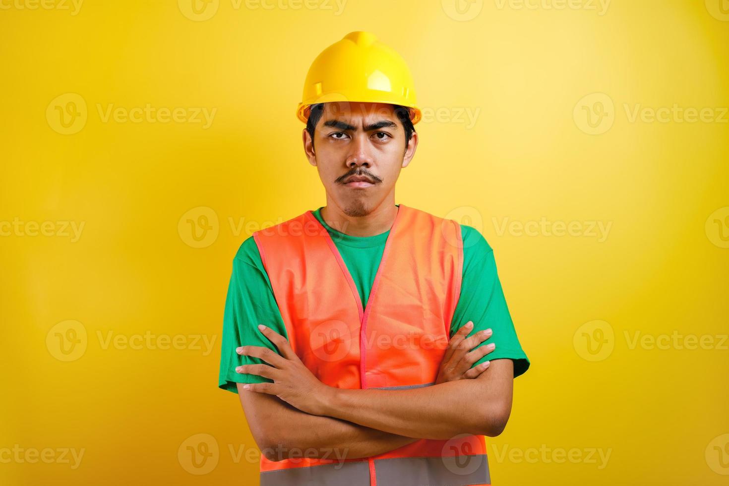 Young handsome asian indian worker man looked angry with crossed arm photo