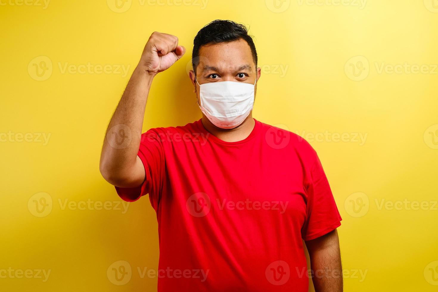 A young asian man wearing a medical face mask that protects against the spread of corona virus disease photo