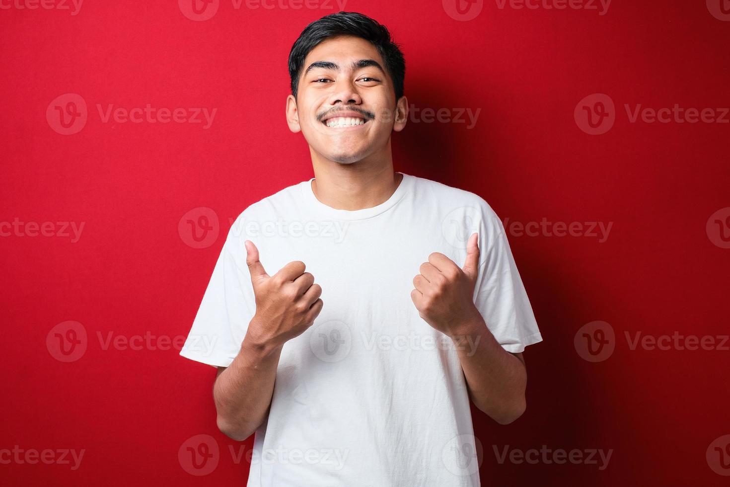 man approving doing positive gesture with hand, thumbs up smiling and happy for success. Winner gesture. photo
