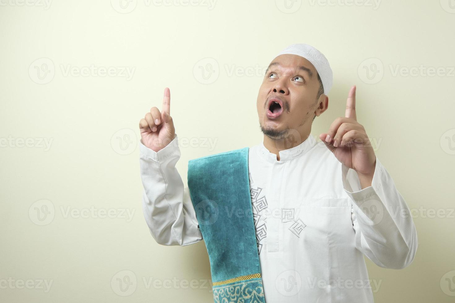 Portrait of young Asian muslim man having good idea photo