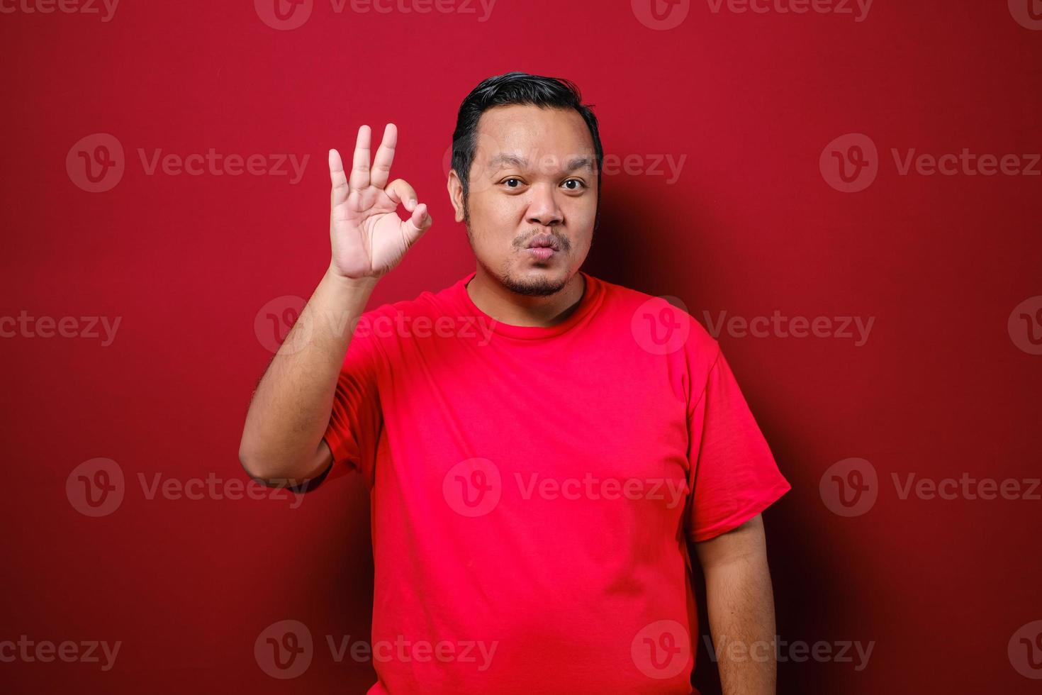 Portrait of happy asian man showing thumbs up photo