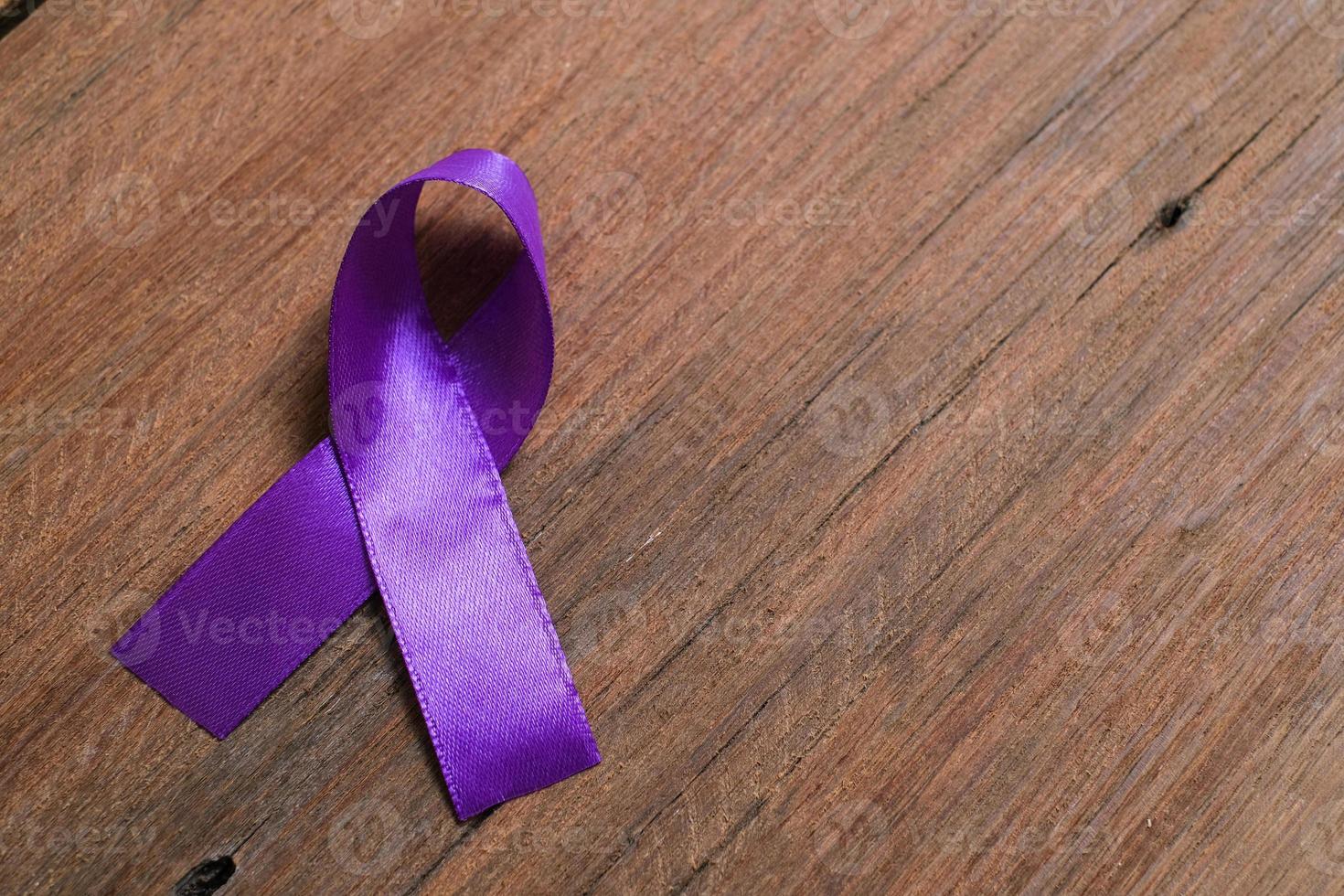 Purple ribbon as symbol of World Cancer Day concept photo