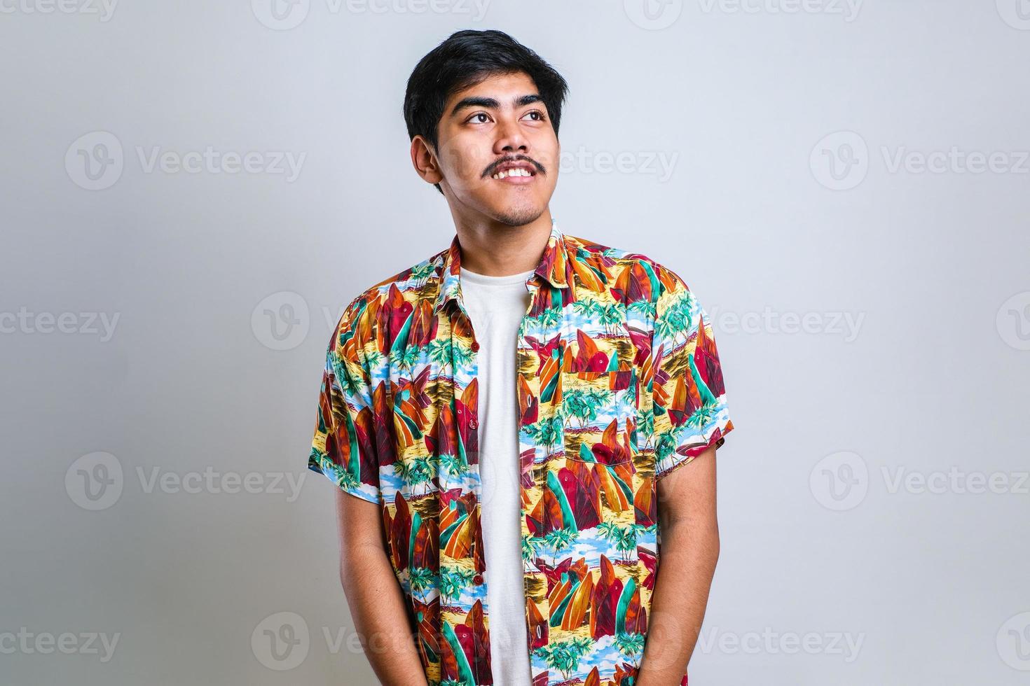 man looking away to side with smile on face, natural expression. Laughing confident. photo