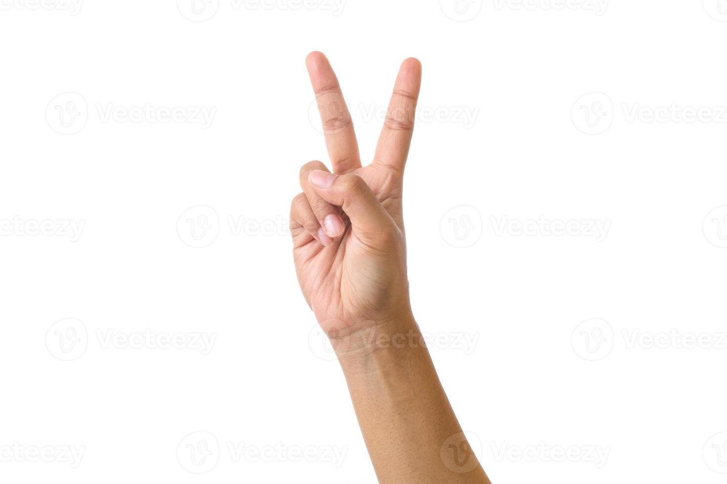 Señal de mano aislada sobre fondo blanco, mano adulta masculina haciendo un signo de paz con dos dedos foto