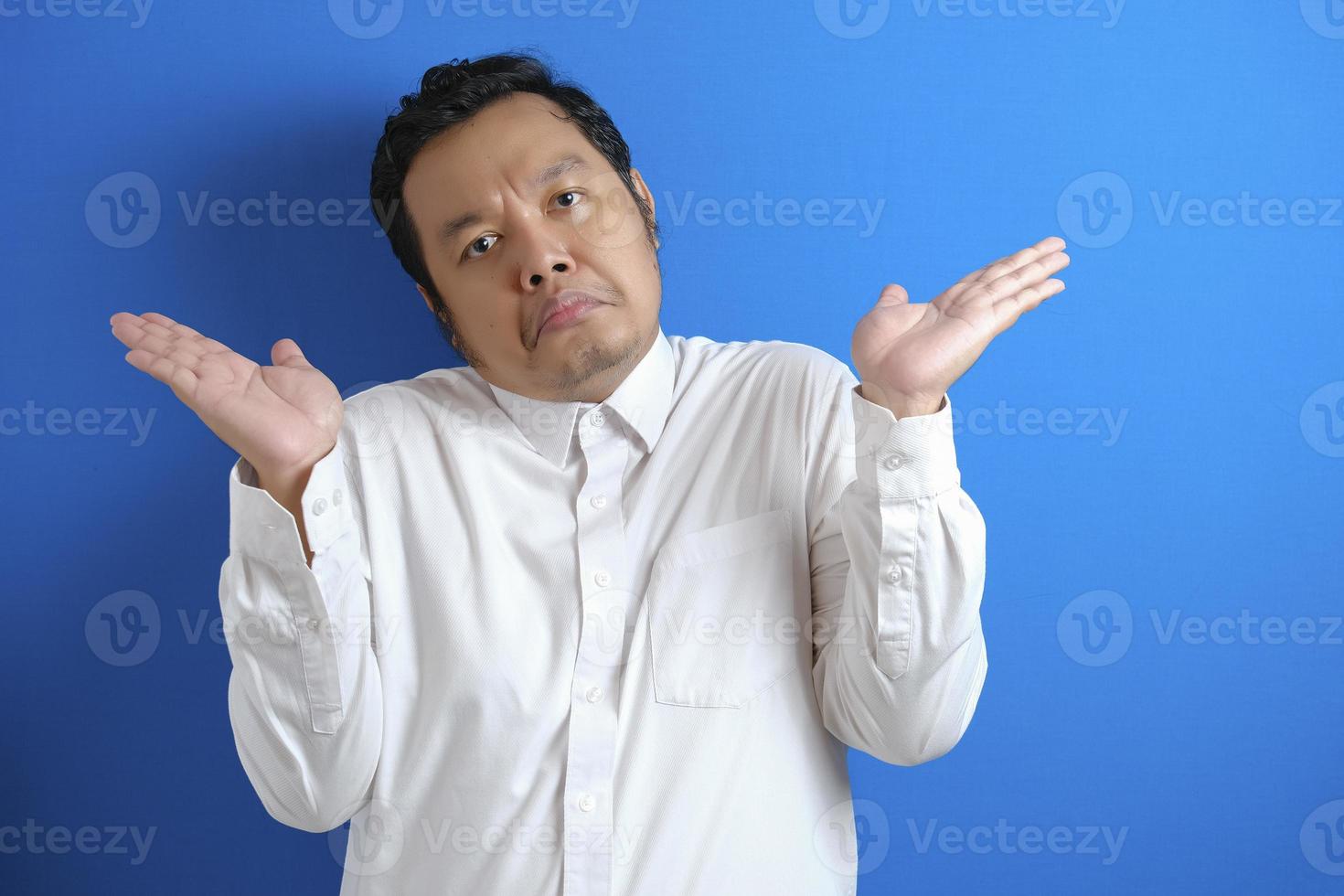 Photo image of Asian businessman with shrug shoulder up gesture