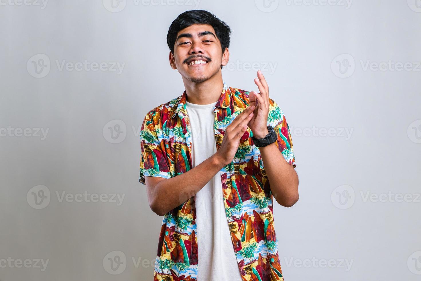man clapping and applauding happy and joyful, smiling proud hands together photo