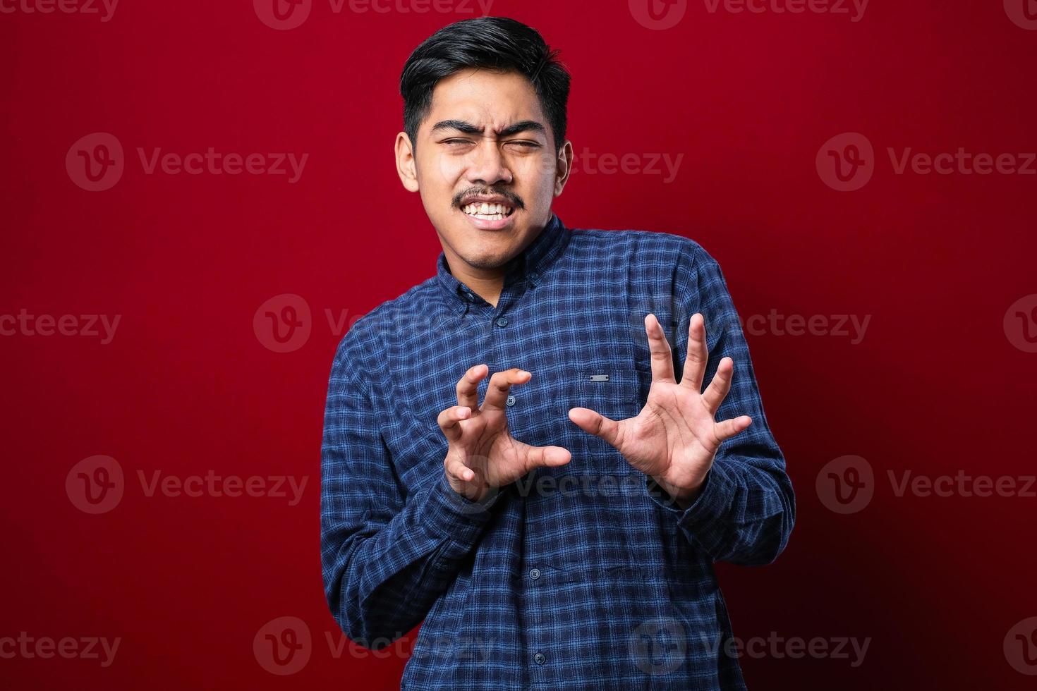 Young handsome asian man wearing casual shirt moving away hands palms showing refusal and denial with afraid and disgusting expression. Stop and forbidden. photo