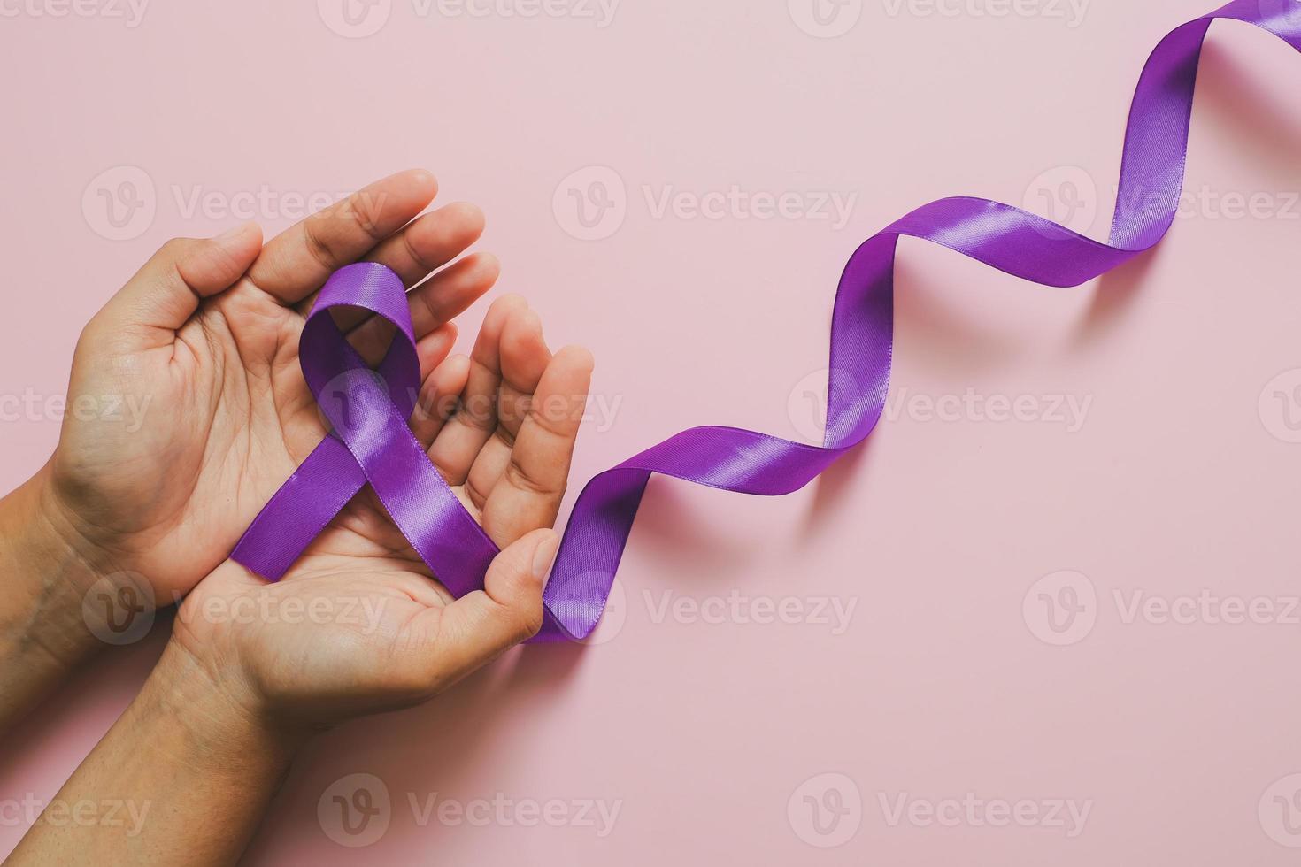 Hands holding Purple ribbons world cancer day concept photo