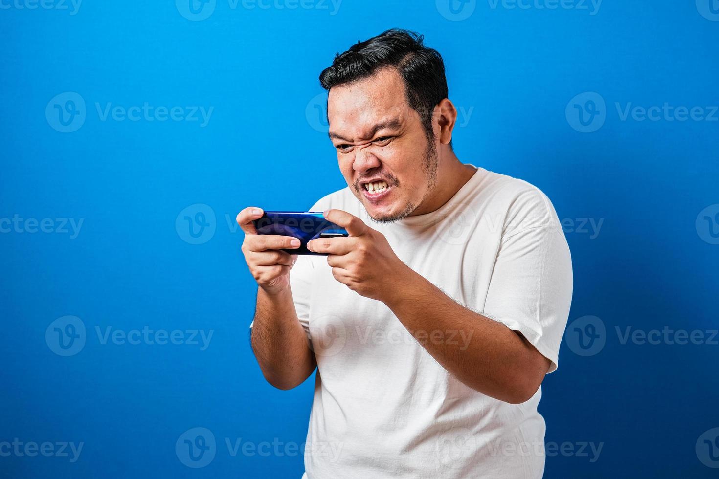 Man Playing Game Seriously With Tablet Stock Photo - Download Image Now -  2015, Adult, Asian and Indian Ethnicities - iStock