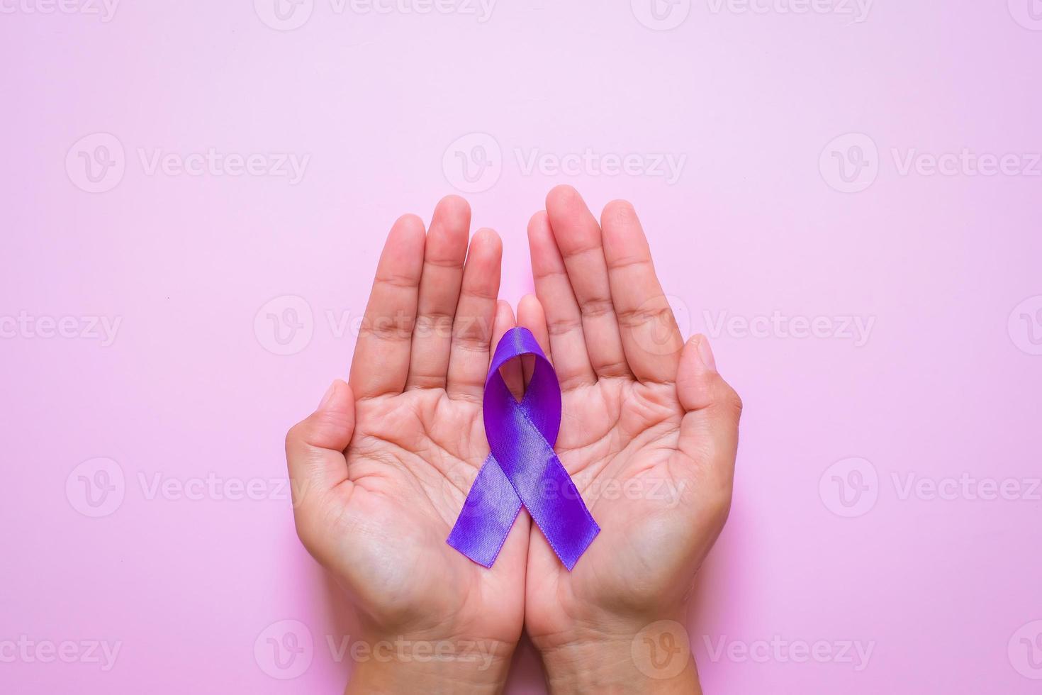 Hands holding Purple ribbons world cancer day concept photo