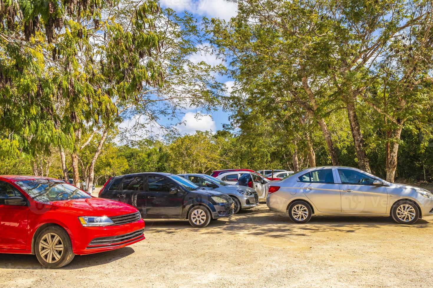 Parking lot with cars jungle to Kaan Luum lagoon Mexico. photo