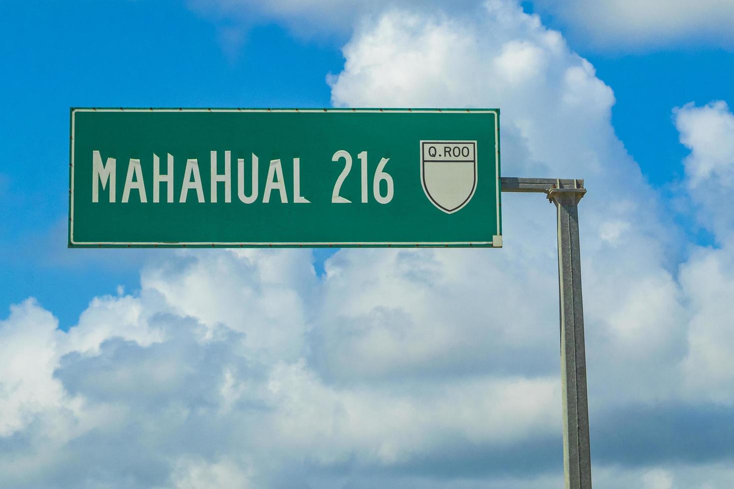 Tulum Mexico 02. February 2022 Police car pickup truck drives fast street road Tulum Mexico.Directional green road sign to Mahahual in Tulum Mexico. photo