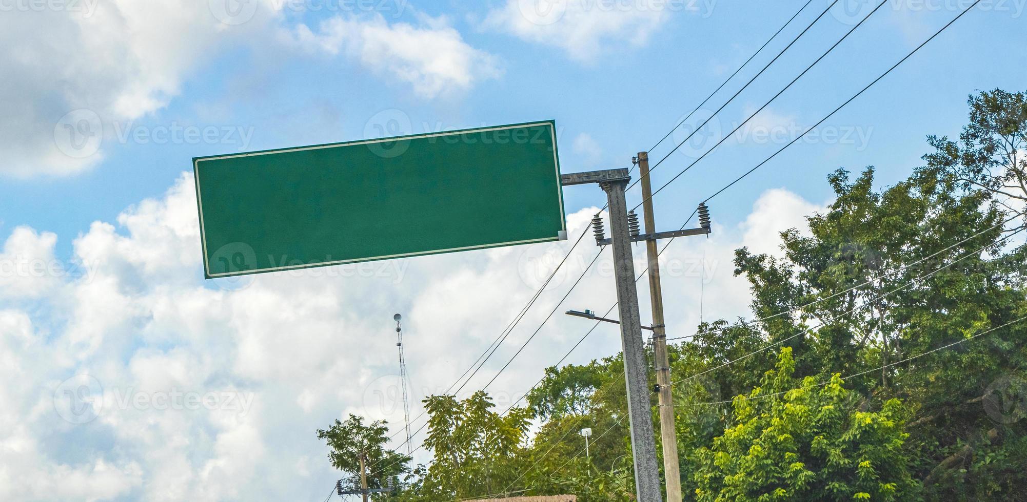 Directional green blank empty road sign in Tulum Mexico. photo