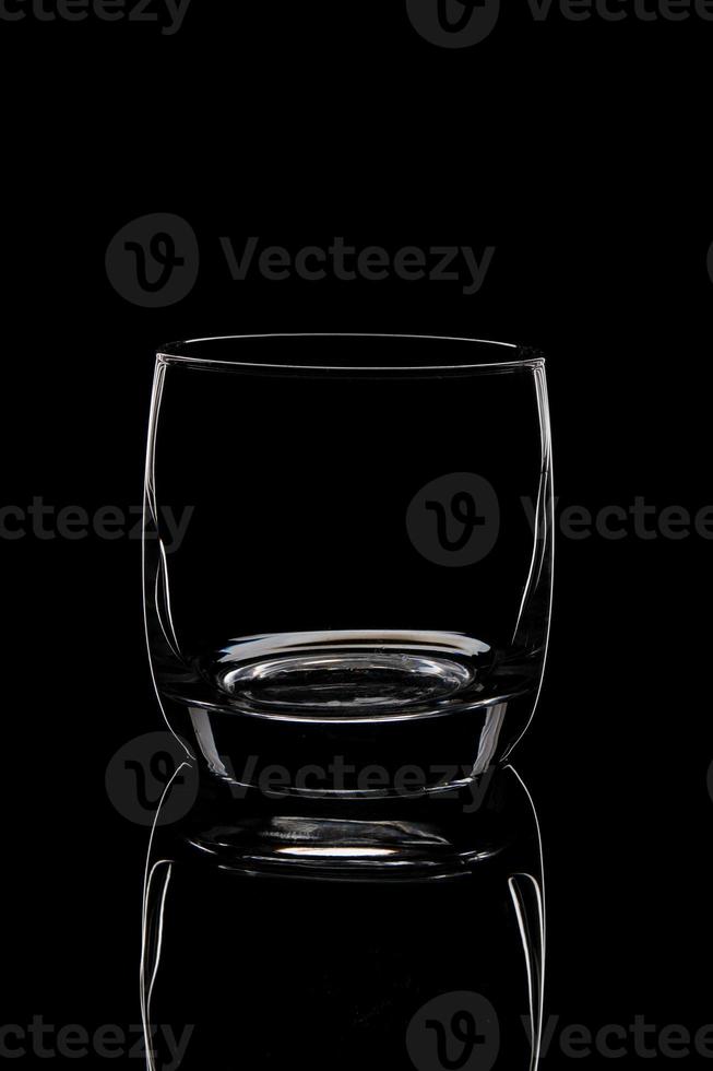 silhouette of an empty glass on a black background photo