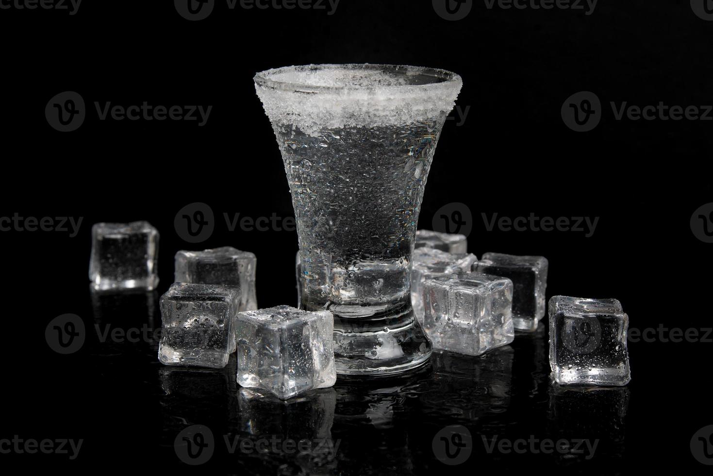 russian vodka with ice on a black table photo