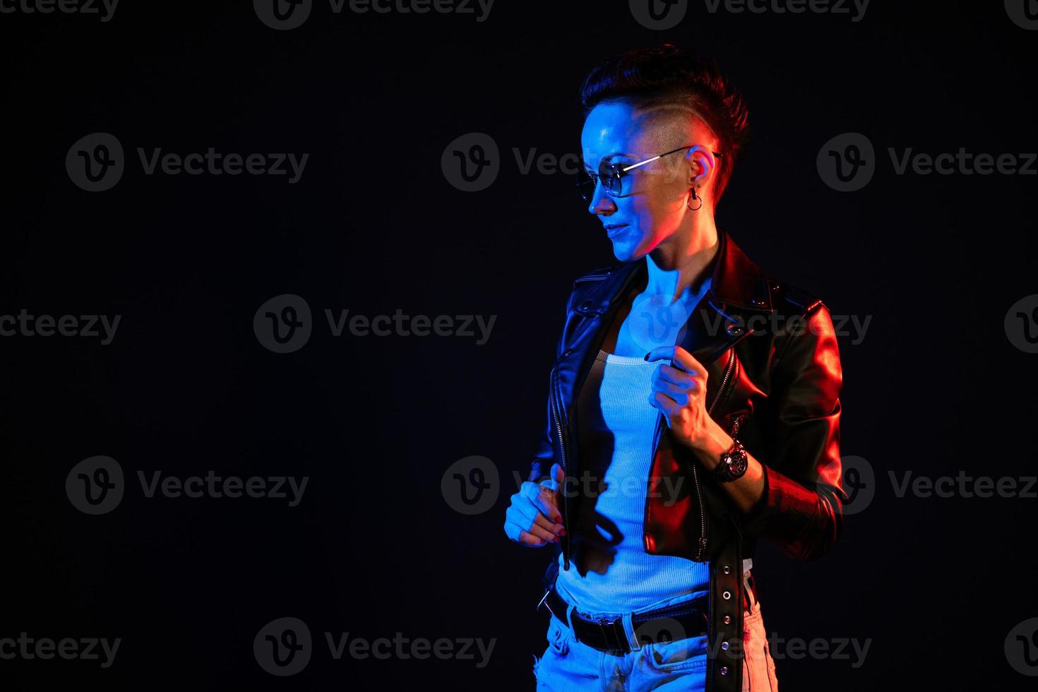 retrato de mujer elegante con pelo corto en chaqueta de cuero y gafas redondas foto