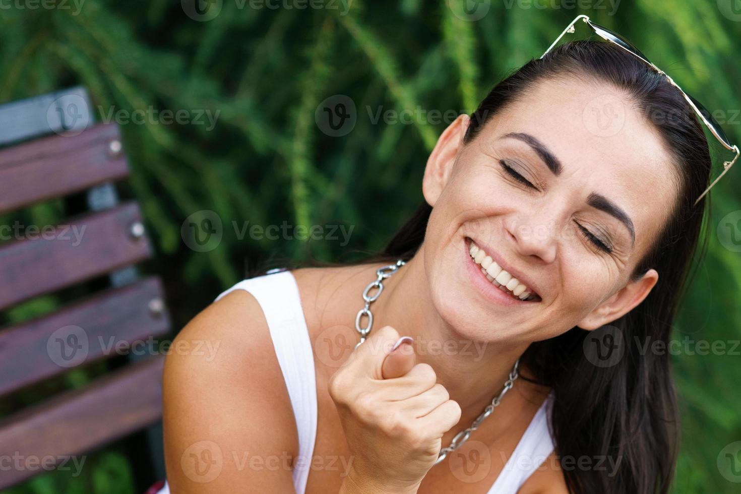 Close-up portrait of a cheerful caucasian woman showing a doo and smiling with photo