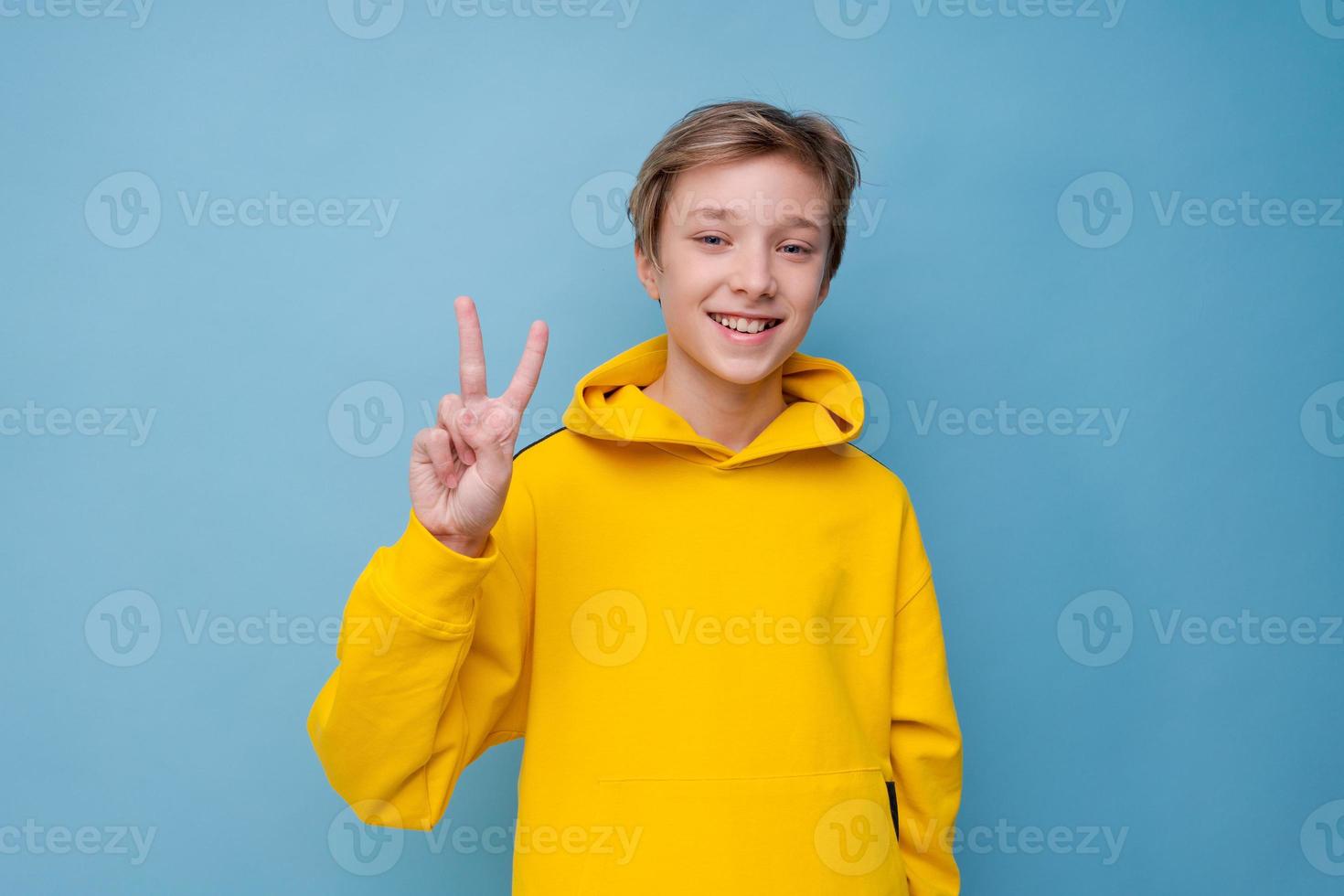 Portrait of attractive young guy showing different hand gestures on blank photo