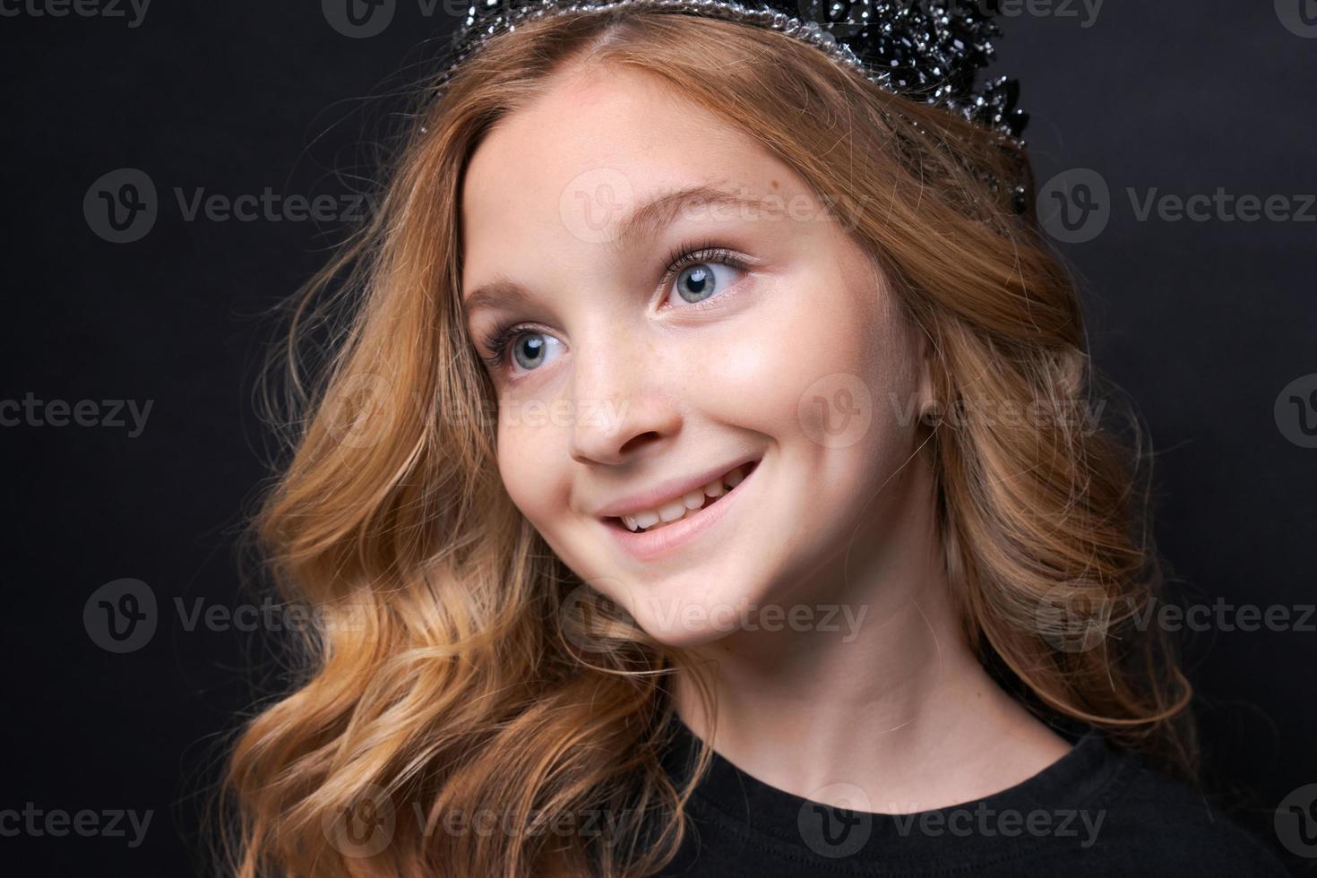 Little funny cute birthday girl, princess 10 years old, wears dark clothes photo