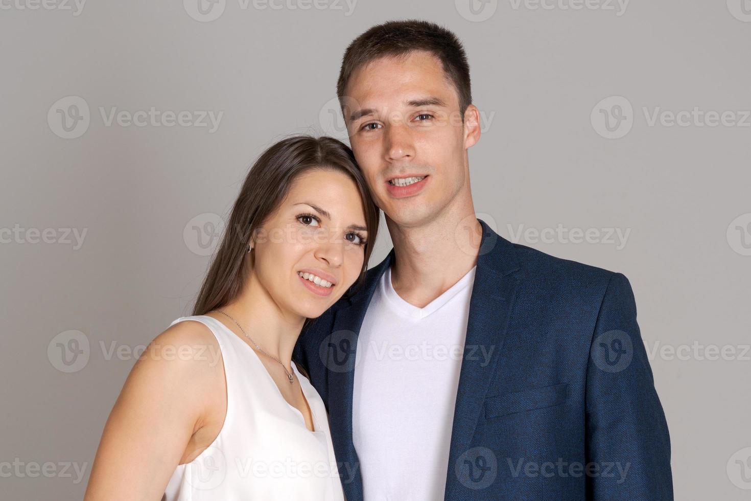 Happy harmonious business people on gray background smiling white man and photo