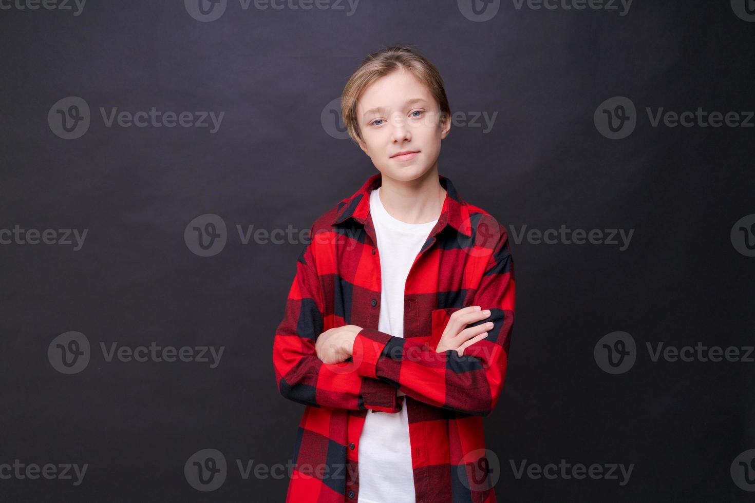 Close-up headshot of confident concentrated young man in plaid shirt looking photo