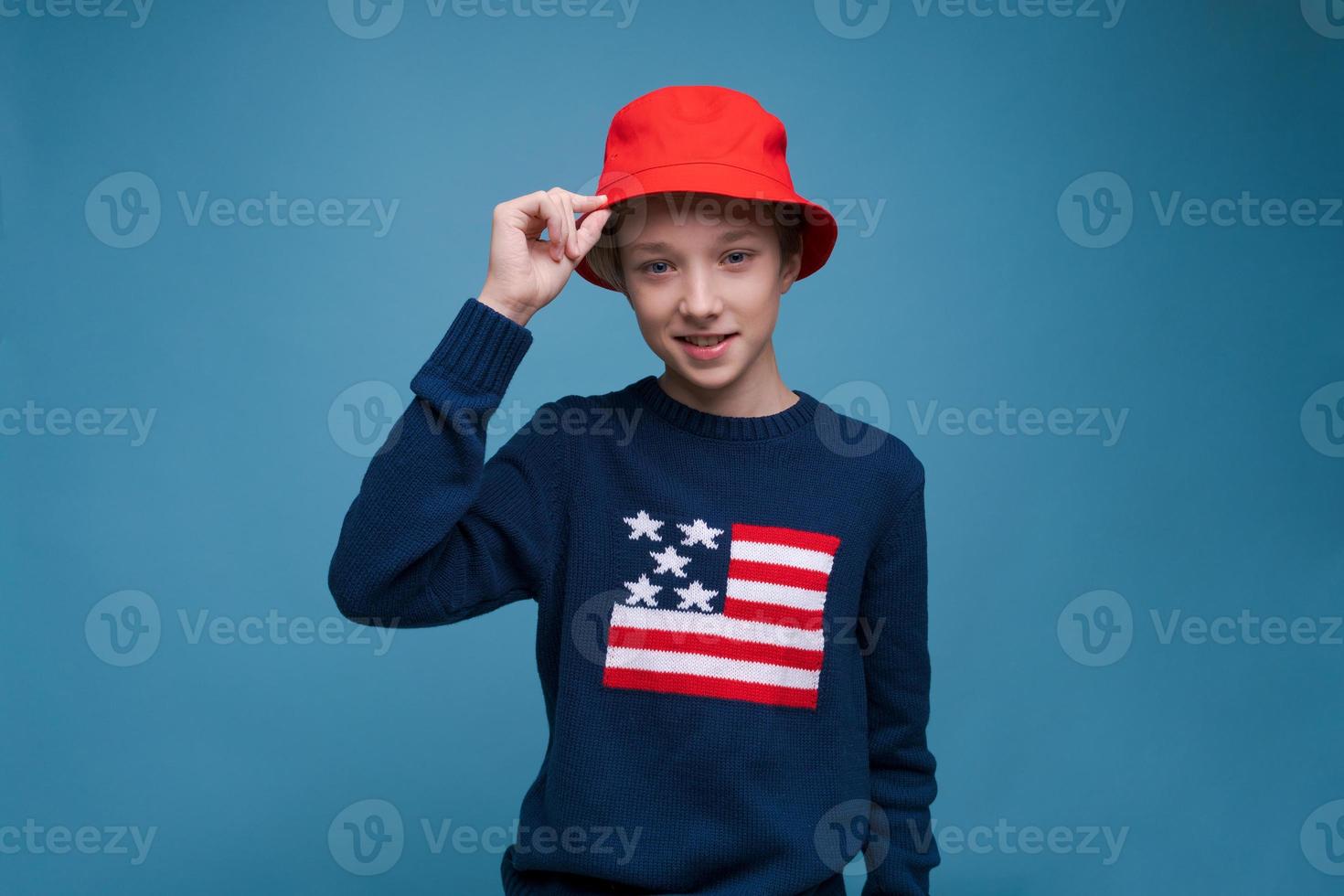 Waist shot happy and contented handsome young man wearing red panama hat photo