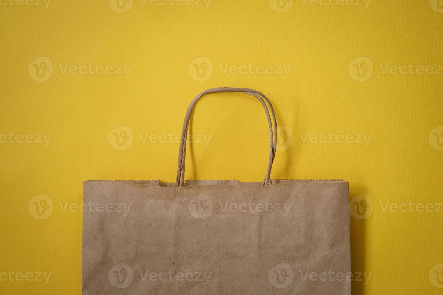 Paper bag on a yellow background photo