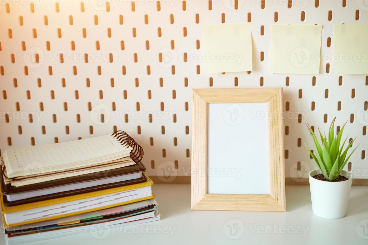 Desktop with notebooks and photo frame