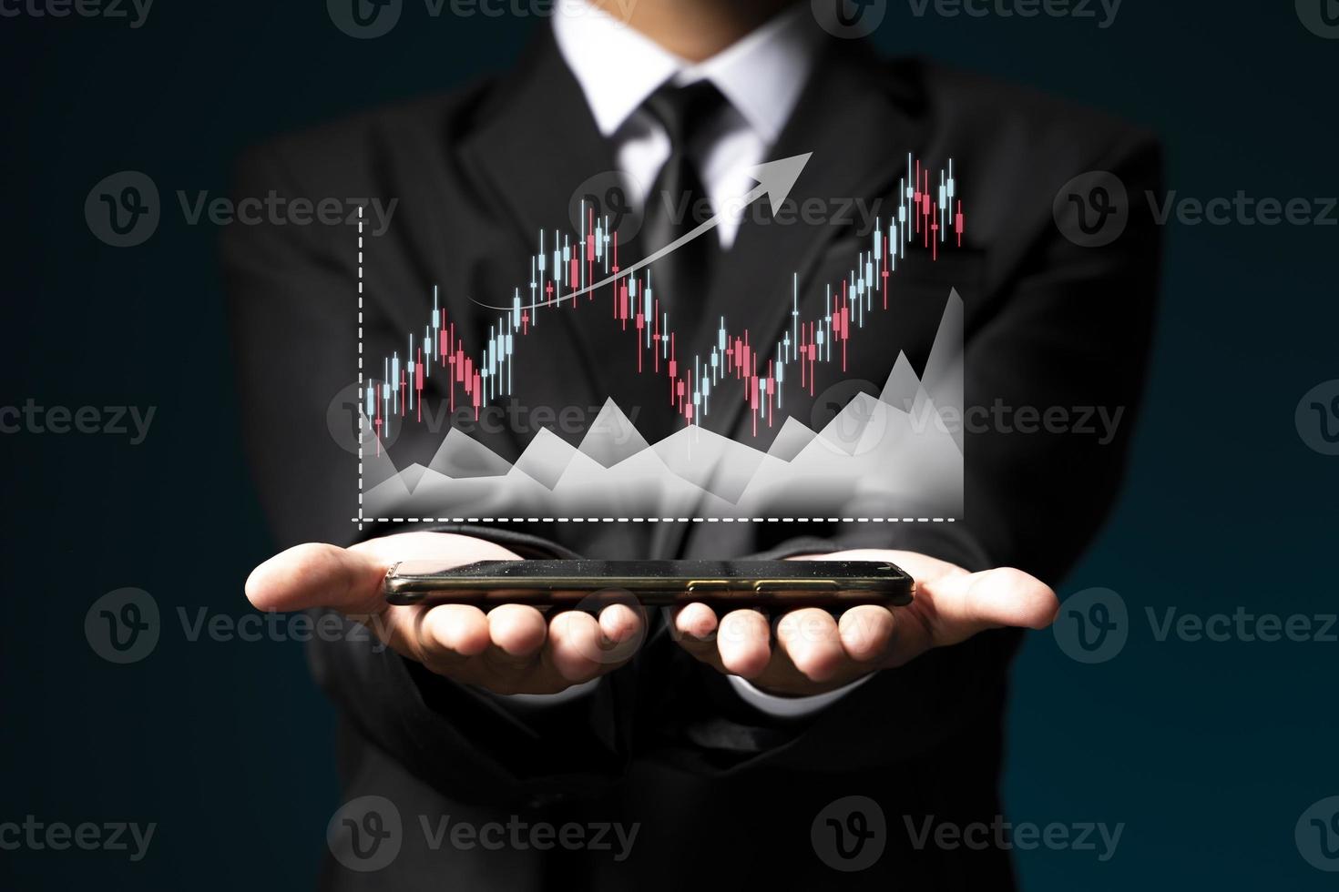 Businessman or trader is showing a growing virtual hologram stock, invest in trading. photo