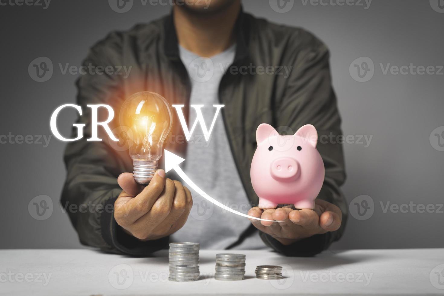 Man putting coin in piggy bank with growing coin. Saving money concept photo