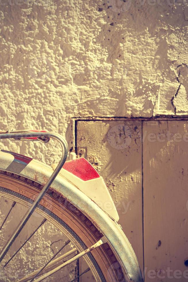 Detail of retro bicycle wheel. It looks part of the rear fender and the brake. Vintage style. Vertical image. photo