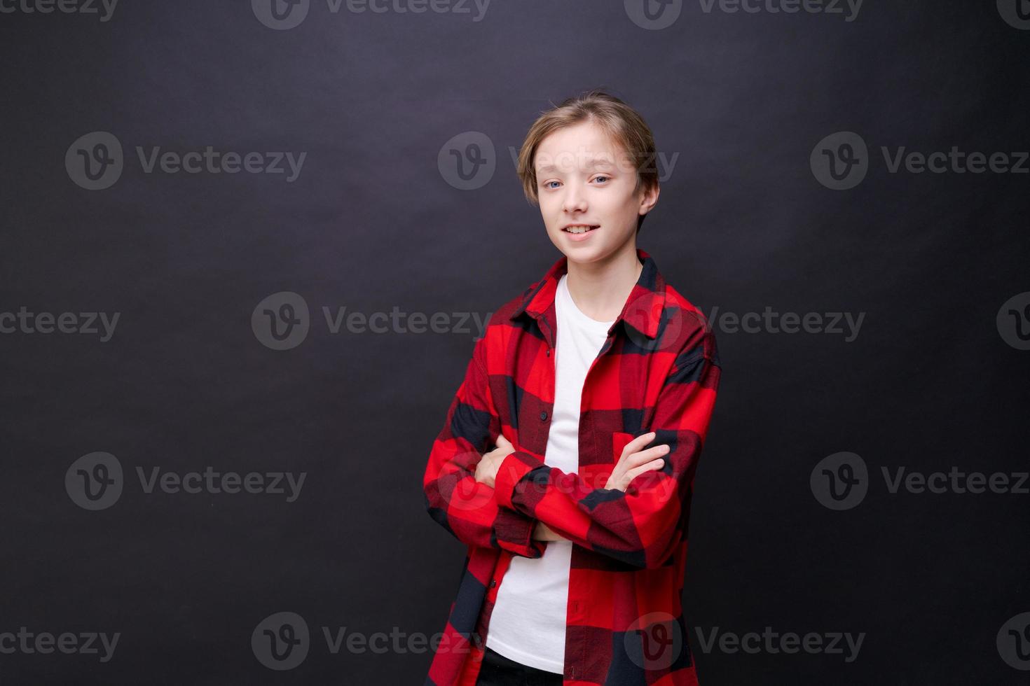 Smiling toothy funny young caucasian teenage guy in simple casual t-shirt photo