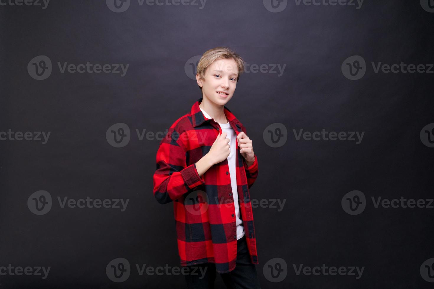 Smiling toothy funny young caucasian teenage guy in simple casual t-shirt photo